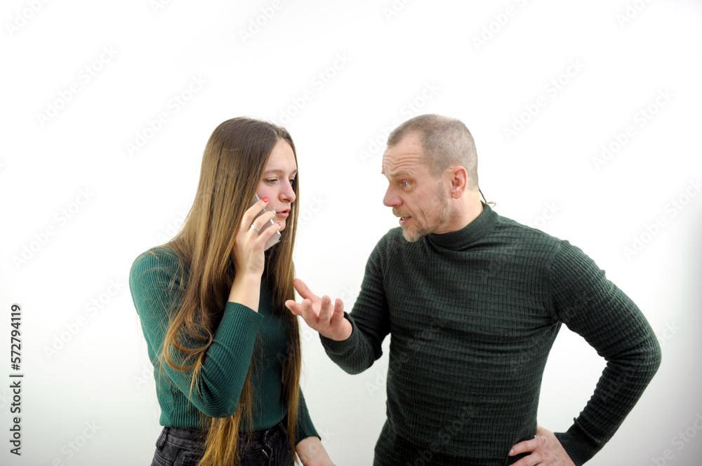 phone in hand, solve problems, litter the phone, swear Man yelling at his woman looking very mad and woman holding her head isolated on white background. High quality photo phone in hand, solve problems, litter the phone, swear Man yelling at his woman looking very mad and woman holding her head isolated on white background. High quality photo