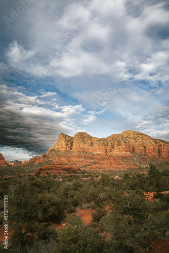 Sunset view of red rock buttes and formations within coconino national forest in Sedona Arizona USA against white cloud background. Horizontal Image.