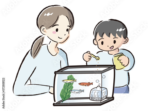 メダカのお世話をする親子（エサやり）