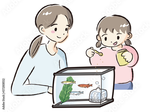 メダカのお世話をする親子（エサやり）