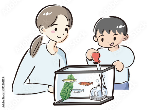 メダカのお世話をする親子（水換え）