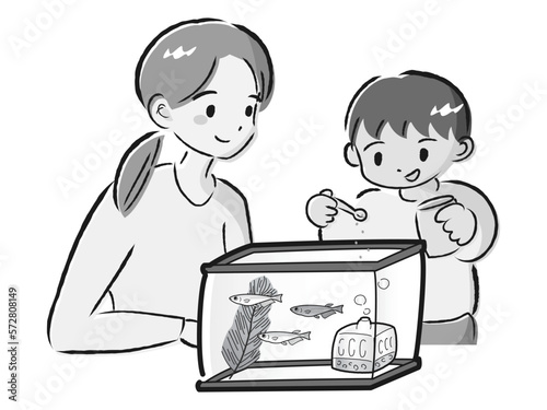 メダカのお世話をする親子（エサやり）