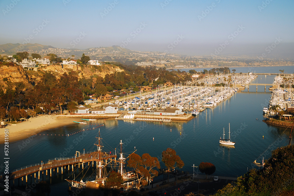 An aerial view from a high cliff gives a splendid view of the marina and harbor of Dana Point, along the Southern California coast - obrazy, fototapety, plakaty 