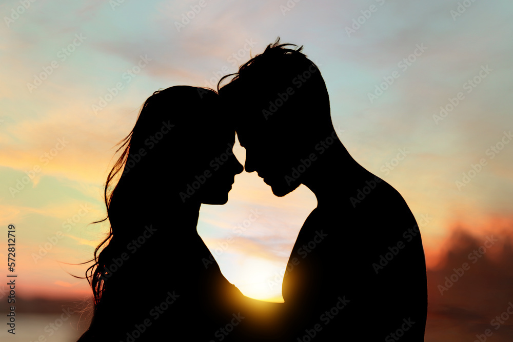 Silhouette of lovely couple enjoying each other at sunset