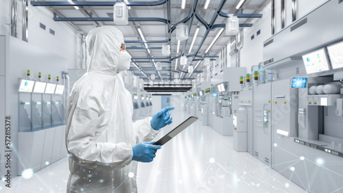 Worker or engineer wears protective suit or coverall suit work in semiconductor manufacturing factory photo