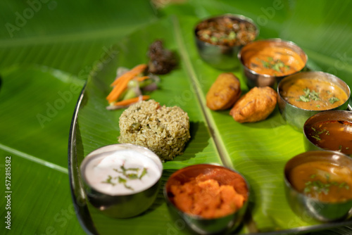 A plate of different vegetarian dishes from the Andhra region in southern India, including fried potato dumplings ('aloo bajji') and spiced rice ('donne biryani').