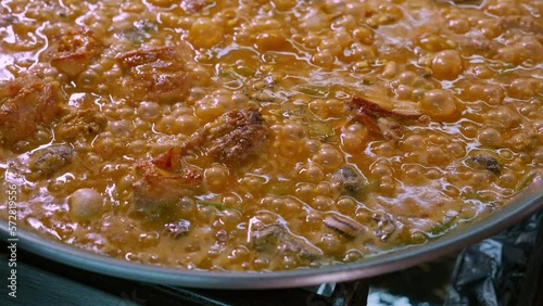 Close-up of a paella with boiling rice photo