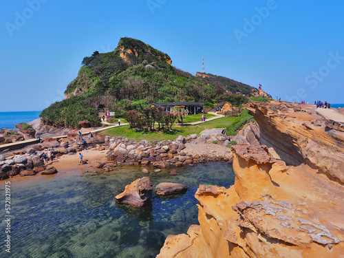 Many tourists visit the popular attraction with strange shape stone at Yehliu Geopark in Wanli District, New Taipei, Taiwan. These rock eroded by wind and sea waves to form a fascinating landscape. photo