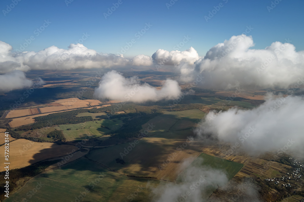 Aerial view at high altitude of earth covered with puffy cumulus clouds forming before rainstorm Aerial view at high altitude of earth covered with puffy cumulus clouds forming before rainstorm
