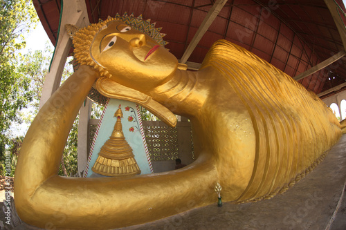 A large golden reclining Buddha image at Wat Somdet , Sangkhlaburi, a historic site in Kanchanaburi , Thailand. A combination of Thai-Raman and Burmese art. photo