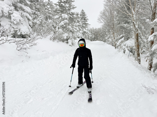 Female skier standing on the slope photo