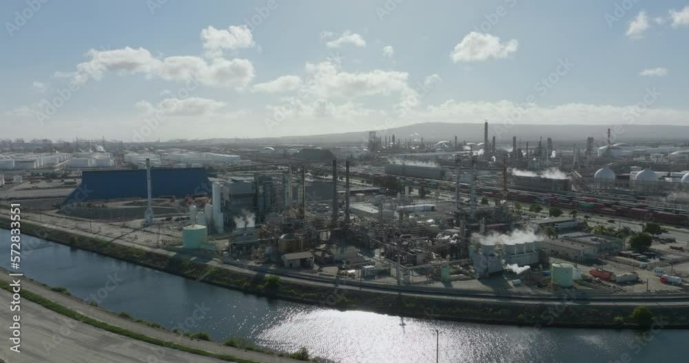 Aerial view of petrochemical oil refinery (refining complex). A huge oil refinery with metal structures, pipes and distillation of the complex. Aerial top down view over oil refinery plant. Aerial view of petrochemical oil refinery (refining complex). A huge oil refinery with metal structures, pipes and distillation of the complex. Aerial top down view over oil refinery plant.
