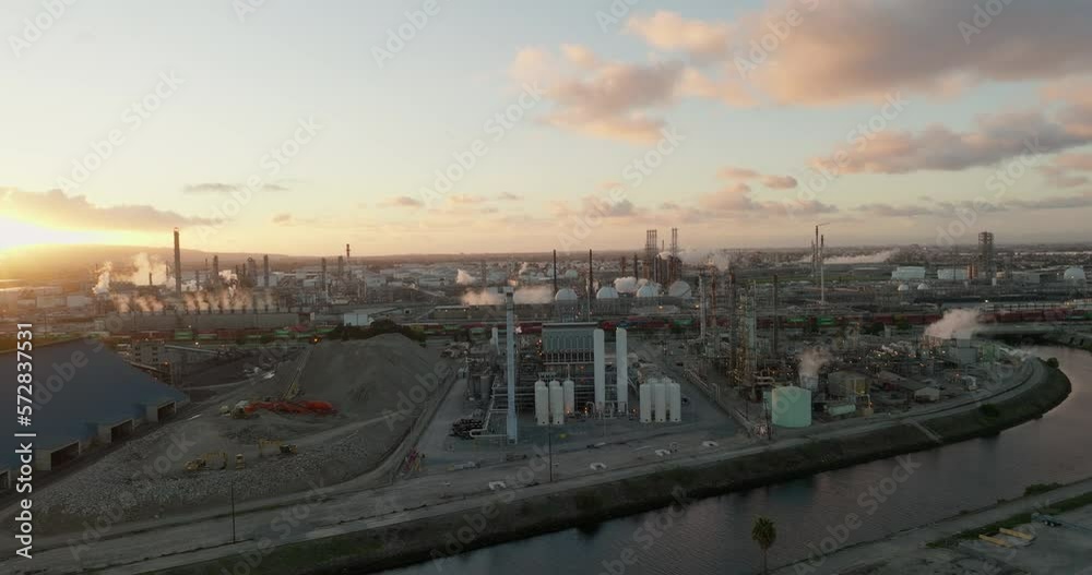 Aerial view of petrochemical oil refinery (refining complex). A huge oil refinery with metal structures, pipes and distillation of the complex. Aerial top down view over oil refinery plant. Aerial view of petrochemical oil refinery (refining complex). A huge oil refinery with metal structures, pipes and distillation of the complex. Aerial top down view over oil refinery plant.