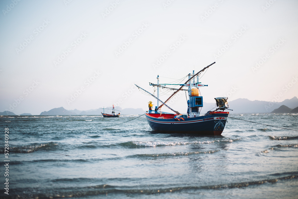 Local fishing boats stop at the beach waiting to go fishing.