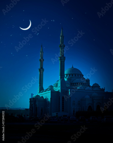 Beautiful mosque illuminated in the soothing blue moonlight. A Ramadan moon and the mosque. Photo of crescent for the occasion of Eid ul fitr. photo