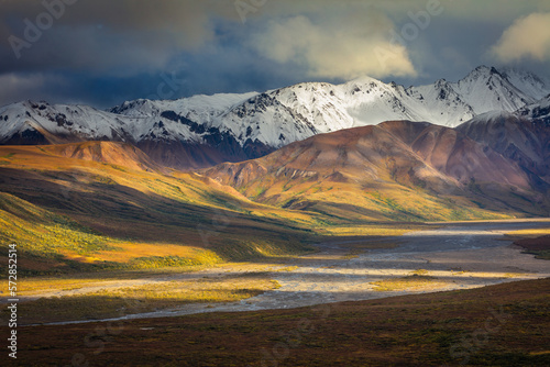 autumn landscape with snow covered mountains, tundra and braiding river, Denali National Park, Alaska