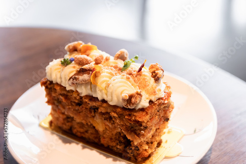 Carrot cake with walnuts, prunes and dried apricots with little edible flower.