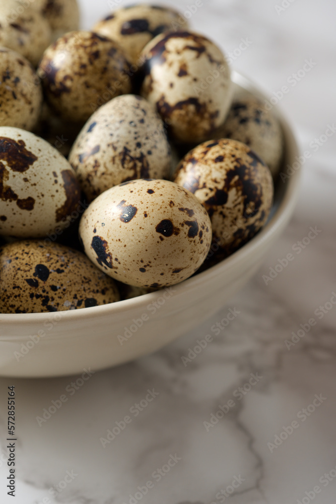 Quail eggs on a marble table.