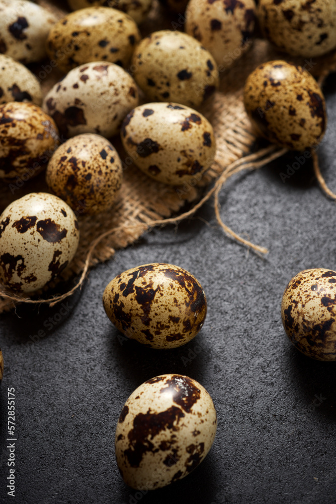 Quail eggs on a black table.