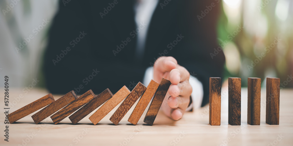 protection and risk management, Financial risk management ,Business Investment Feasibility Assessment, protection of business interests, Human hands blocking wooden sticks - obrazy, fototapety, plakaty 