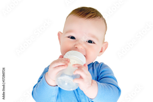 Happy infant baby lies in bed with a bottle of milk in his hands, isolated on a white background. Smiling child in a crib. Kid aged six months