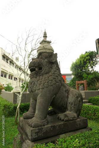 a lion statue in front of Budi Bhakti Temple photo