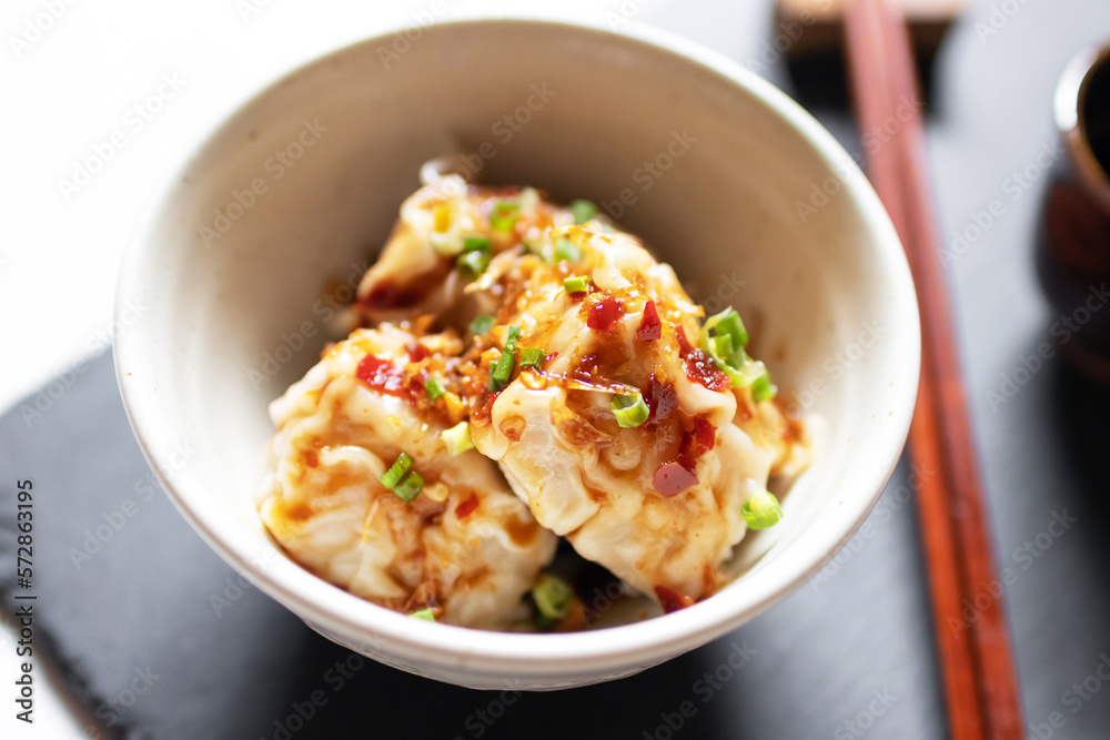 Steamed dumpling stuffed ground shrimp and pork dipping sweet chili sauce with fried garlic and spring onions.