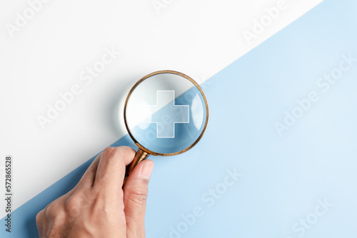 Health insurance healthcare medical concept. Hand people holding Magnifier focus to plus symbol icon, health and access to welfare health concept...