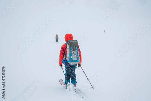 A skier moves quickly as snow falls towards a white horizon during the Spearhead Traverse in the Coast Mountains of British Columbia, Canada. photo