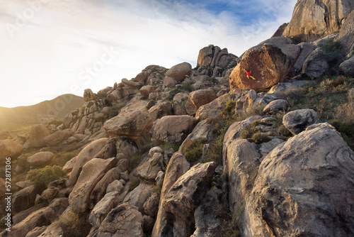 Climber in a sea of boulders as the sun rises in PeÃ±oles, Chihuahua. photo