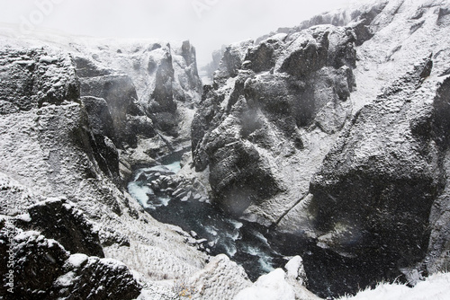 Blizzard at snowcappedÂ Fjadrargljufur canyon, Iceland photo