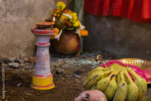 Clay lamp on pilsuj stand burning with yellow flame illuminated for hindu pooja rituals like durga puja, saraswati, diwali holi etc.. photo