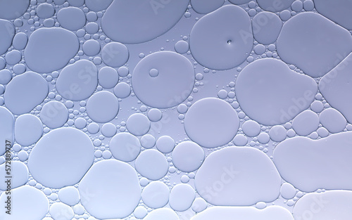 Water and oil droplets to creating bubbles and pattern on pale purple greadient background. 