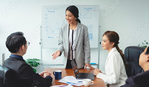 Asian businesswoman presenting of his work to corporate colleagues in meeting in office. businesspeople discussion during meeting about project of company.