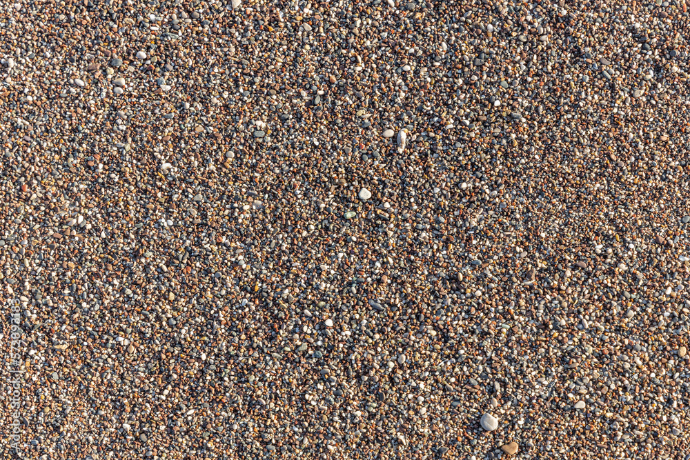 Beautiful horizontal texture of yellow sand with waves pebbles and shells is in the photo Beautiful horizontal texture of yellow sand with waves pebbles and shells is in the photo