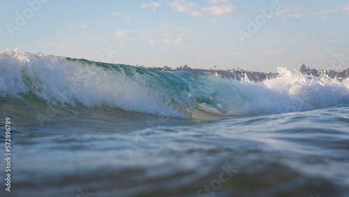 Wave breaking on the beach shore.