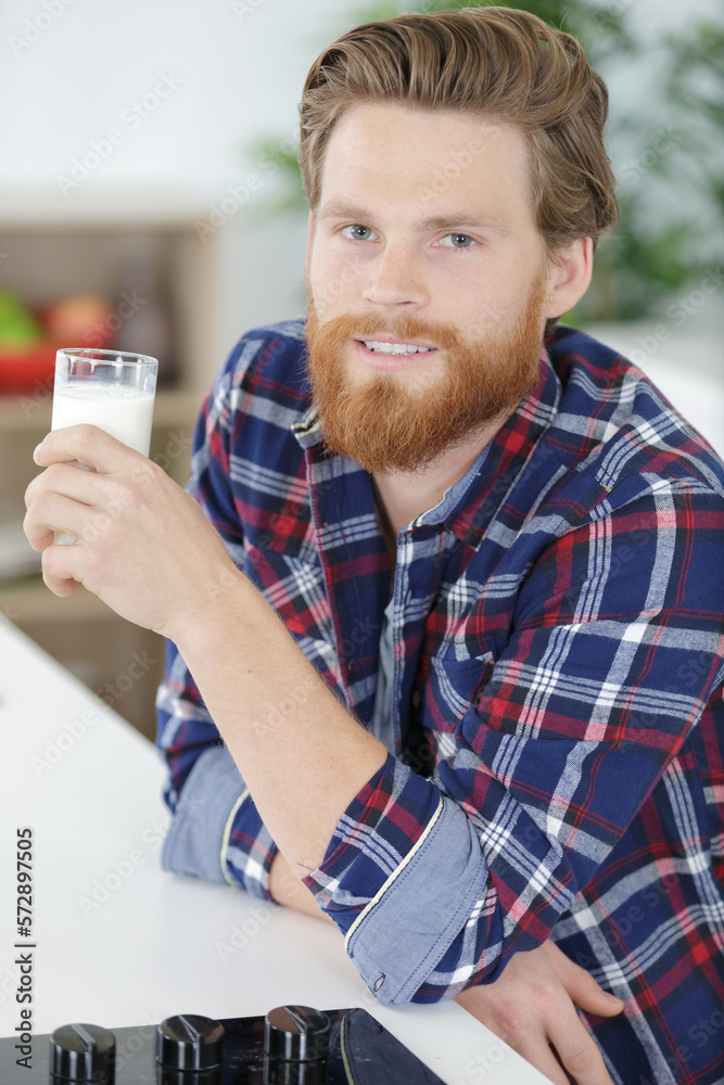 handsome young man drinking milk