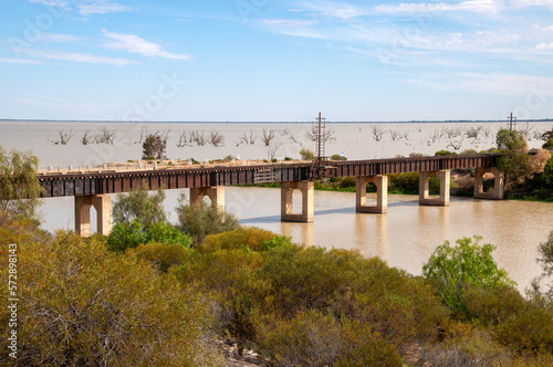 Menindee Australia, view of train tracks crossing river as it meets lake