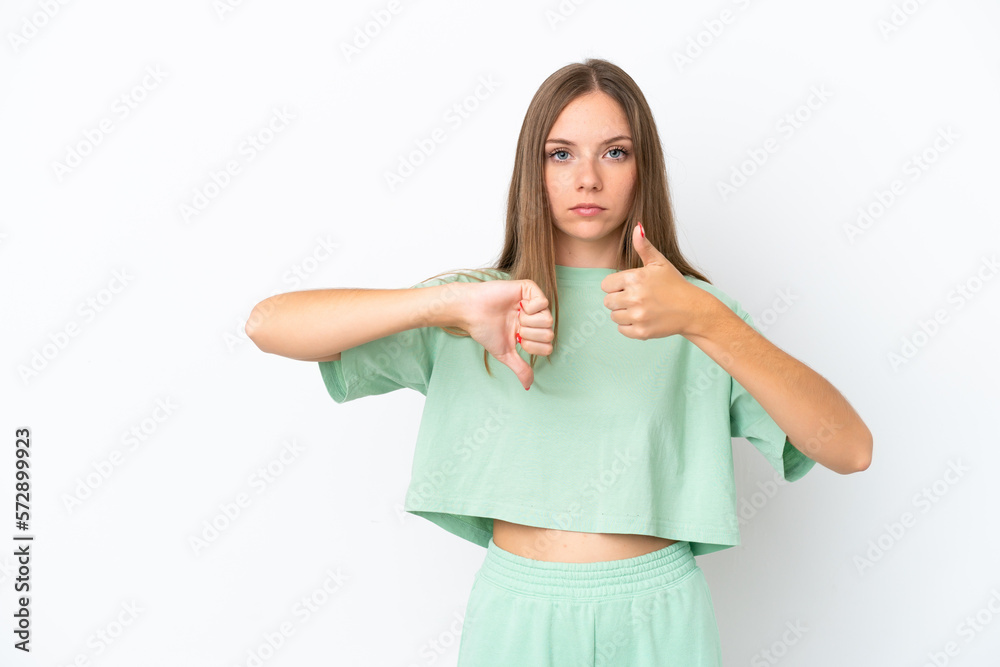 Young Lithuanian woman isolated on white background making good-bad sign. Undecided between yes or not