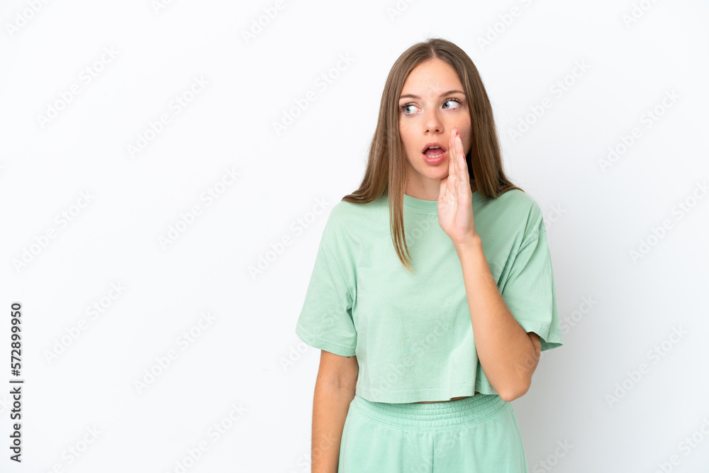 Young Lithuanian woman isolated on white background whispering something with surprise gesture while looking to the side Young Lithuanian woman isolated on white background whispering something with surprise gesture while looking to the side
