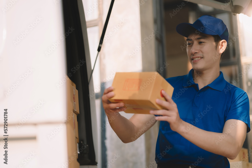 Asian delivery man, delivery men unloading cardboard boxes from truck. Asian delivery man, delivery men unloading cardboard boxes from truck.