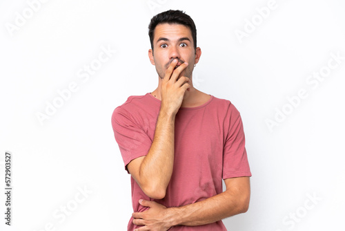 Young handsome man over isolated white background surprised and shocked while looking right