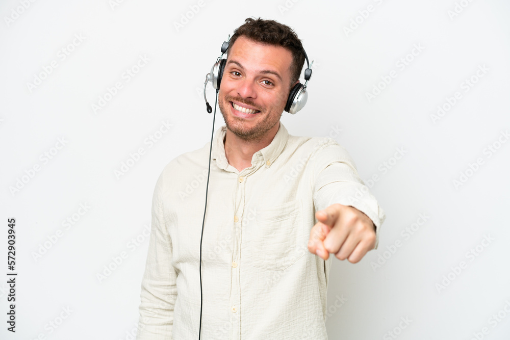 Telemarketer caucasian man working with a headset isolated on white background points finger at you with a confident expression Telemarketer caucasian man working with a headset isolated on white background points finger at you with a confident expression