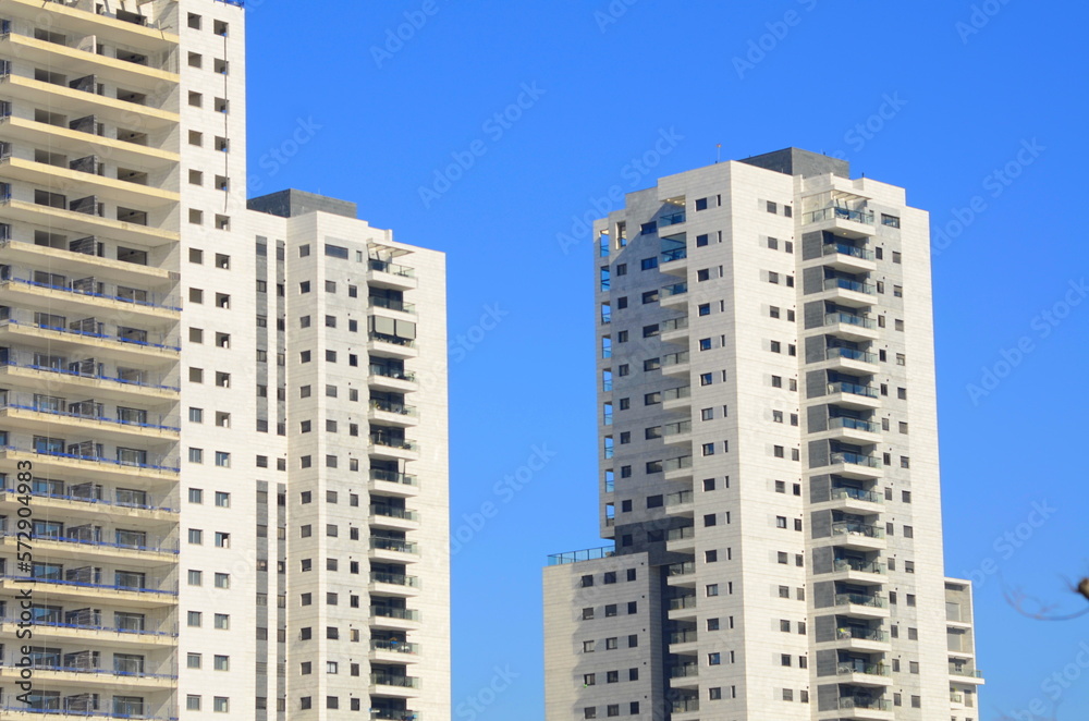 Beautiful white residential buildings. Modern area, new buildings. Real estate in Israel. Tenement house Tall new residential buildings against the sky, space for text