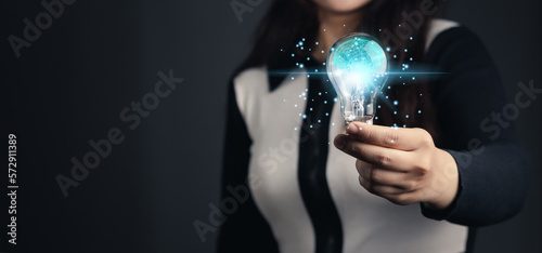 Creativity and innovative are keys to success. Woman holding drawing lightbulb with brain on grey background for creative and smart thinking idea concept.