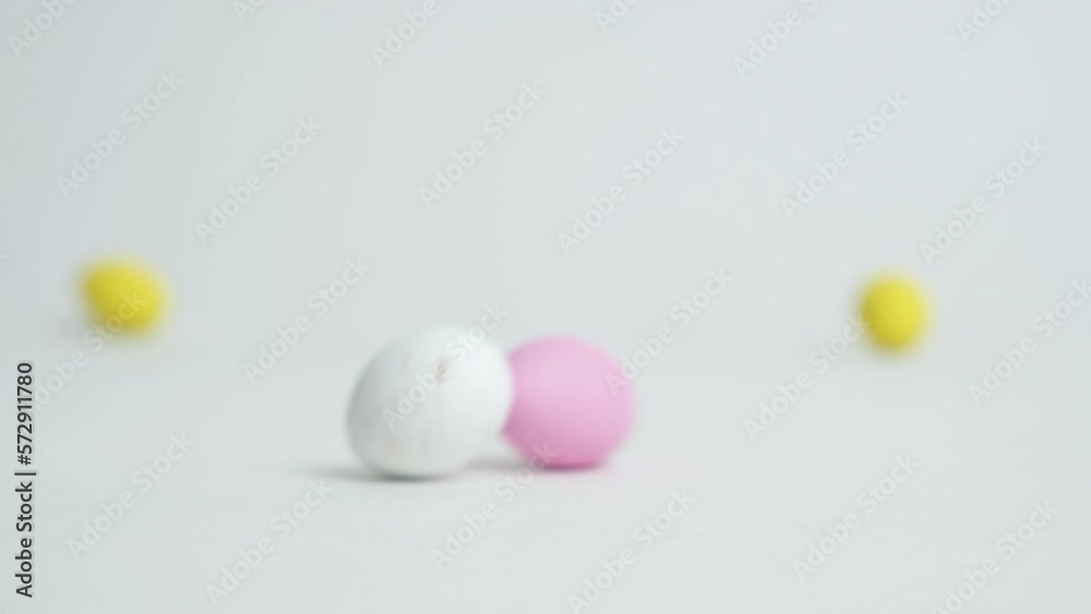 Easter quail chocolate eggs roll quickly across the white background. Easter Sale.