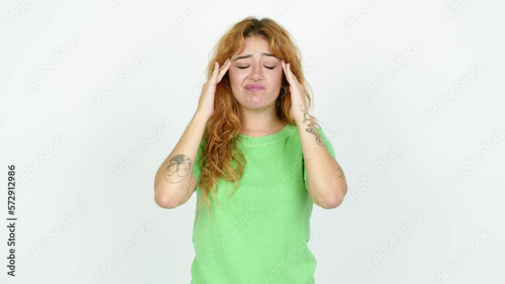 Young redhead woman unhappy and frustrated with something over isolated background Young redhead woman unhappy and frustrated with something over isolated background