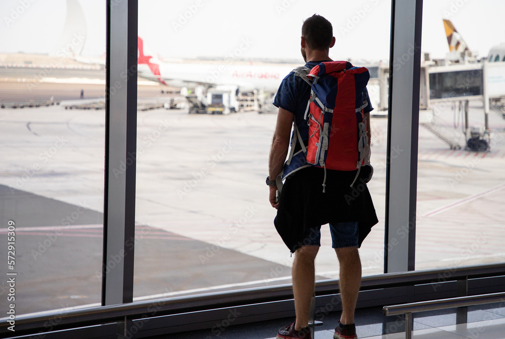 Obraz premium handsome man with backpack waiting in airport
