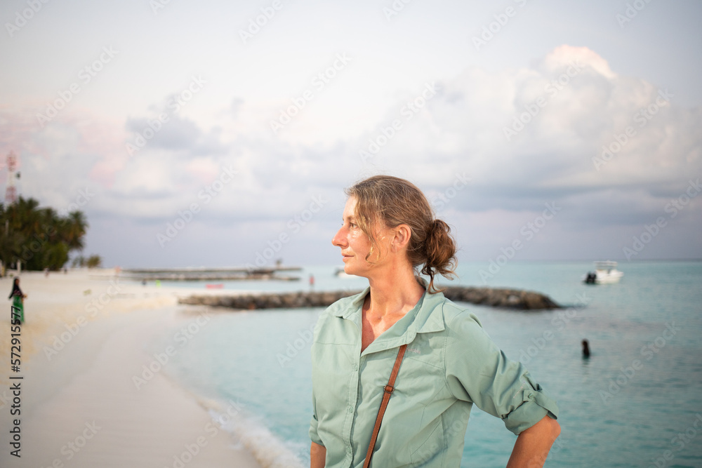 woman looking at pink sunset over tropical sea freedom woman looking at pink sunset over tropical sea freedom