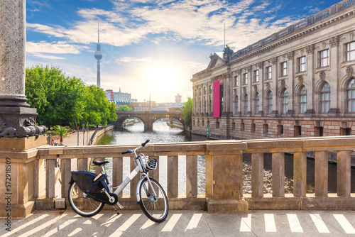 Obraz na płótnie Bike in a good weather on the Bridge over the river Spree in Berlin near the TV tower and museums, Germany w salonie